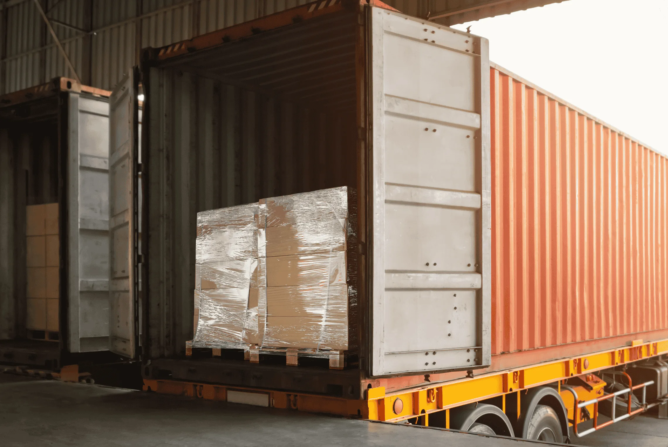 A rigid truck being loaded with safely wrapped pallets at an Australian distribution centre